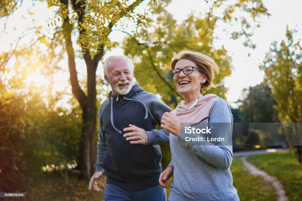 Happy couple jogging outdoors in a park